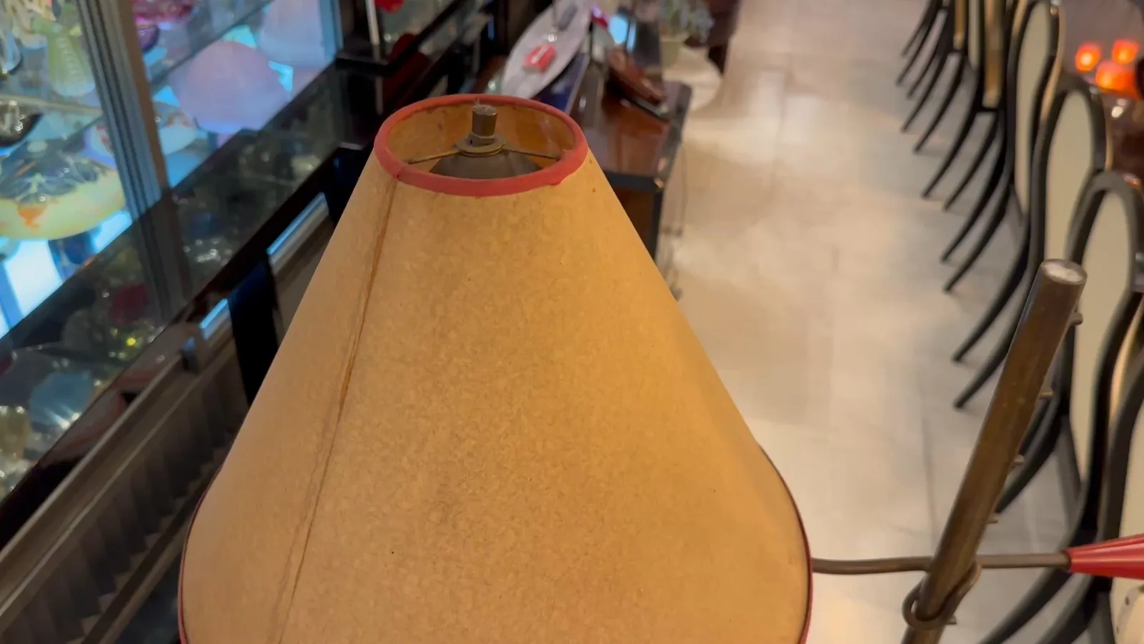 antique floor lamp with a beige shade in a classic setting