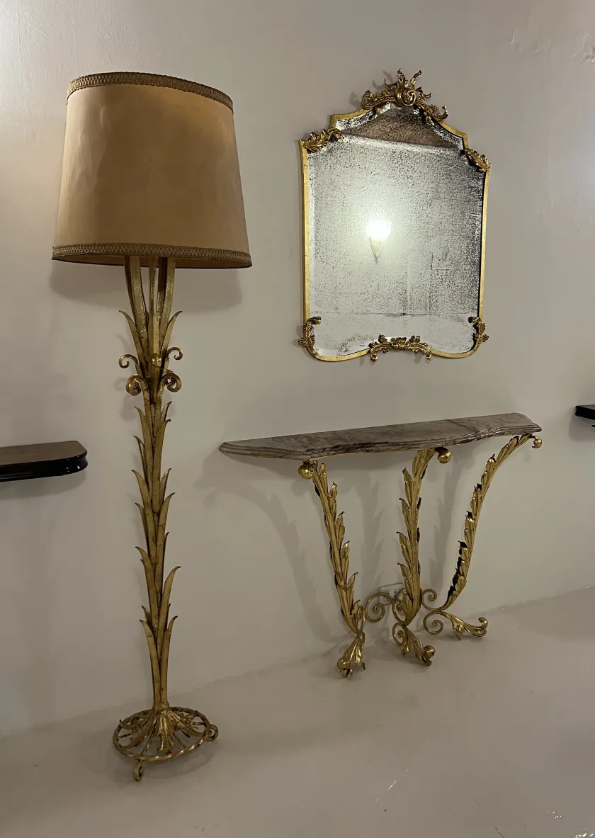 Antique floor lamp with a beige shade and ornate base.