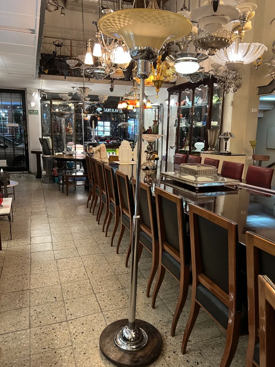 Antique floor lamp with elegant design in a decorative setting.