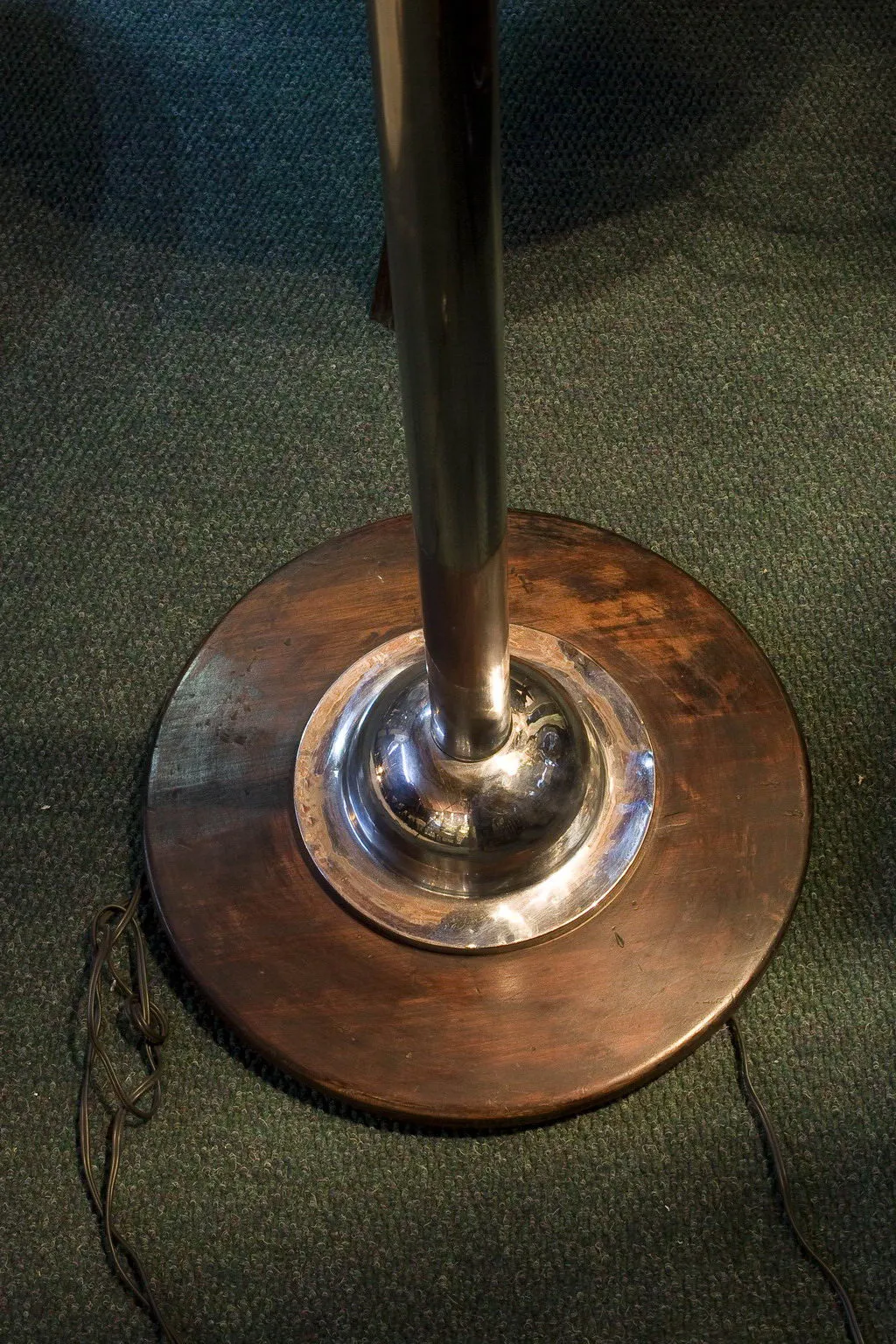 Antique floor lamp with elegant base and visible cord