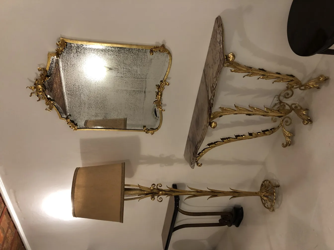 Antique floor lamp with gold base and beige shade in an elegant setting