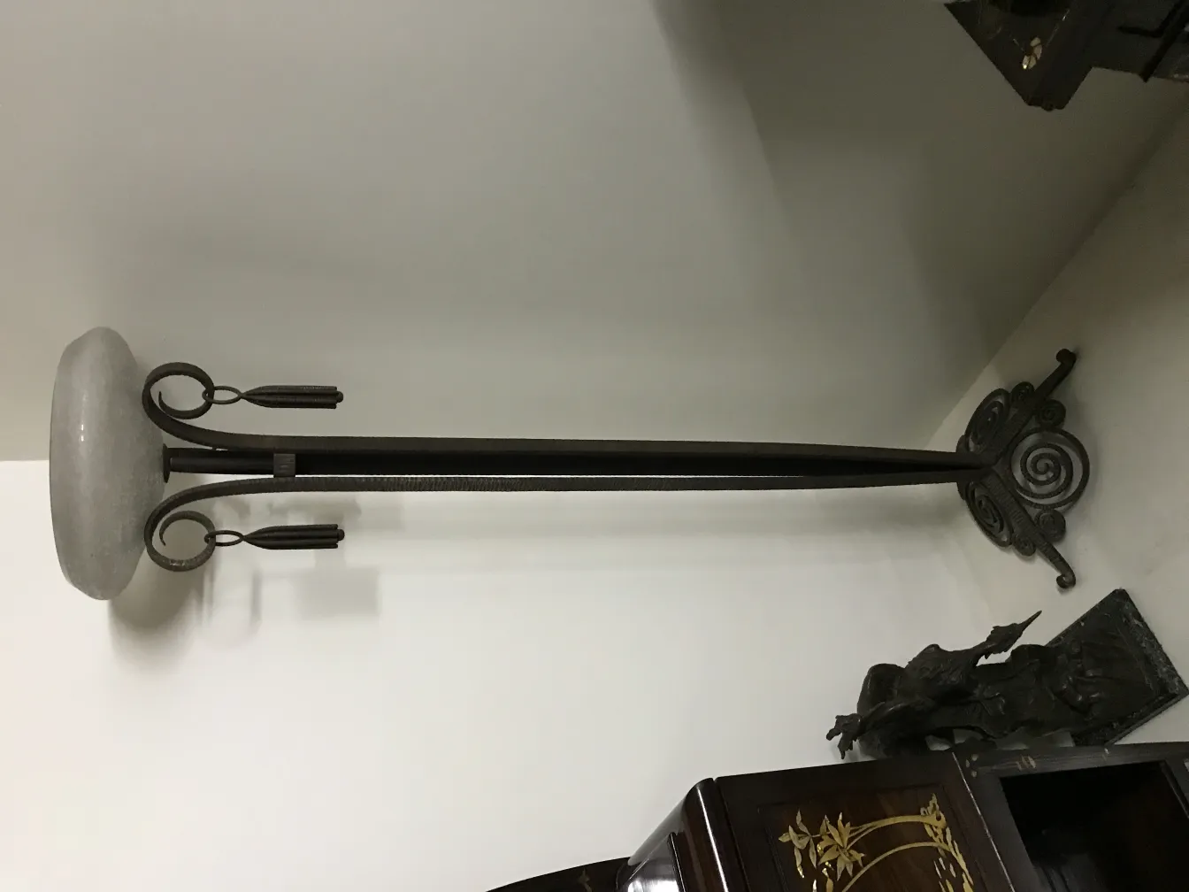 Antique floor lamp with elegant design base, cozy atmosphere.