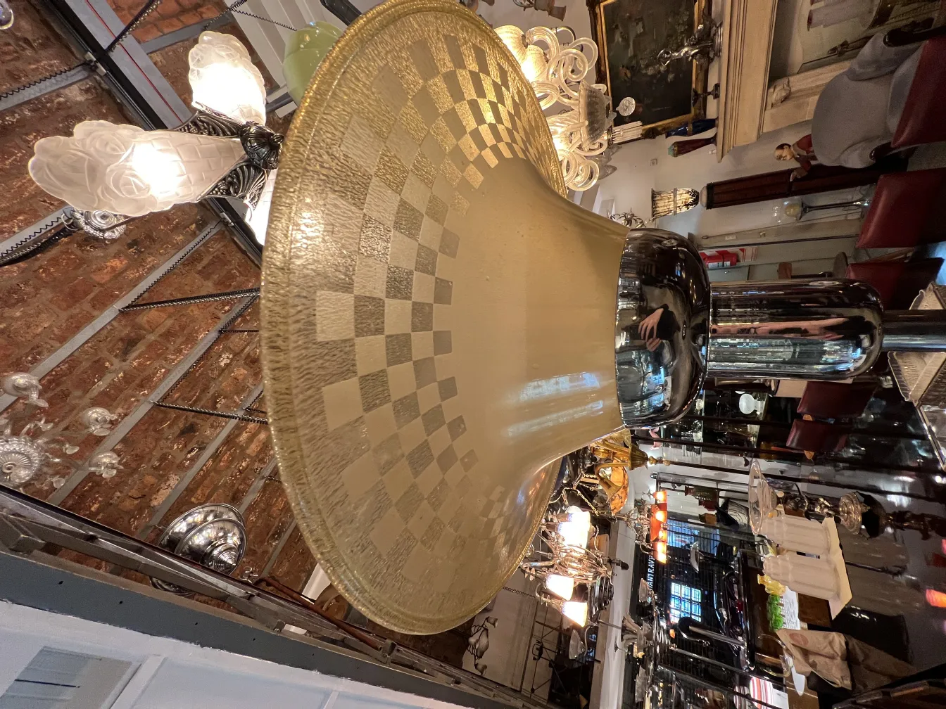 Antique floor lamp with a wide glass shade, surrounded by a classic environment with other decorative elements