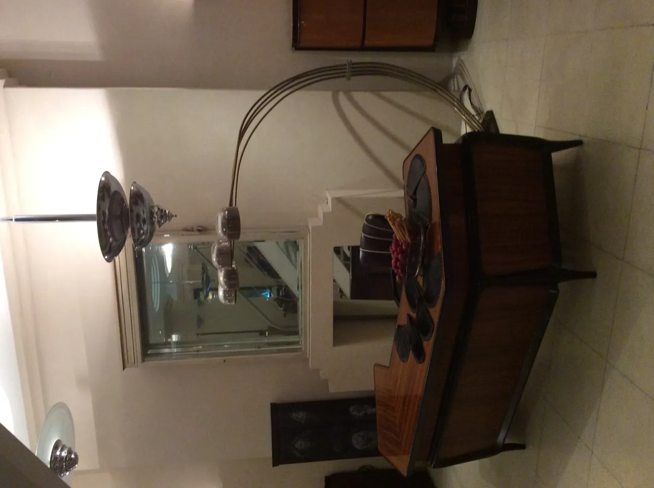 Antique floor lamp with curved design and multiple lights.