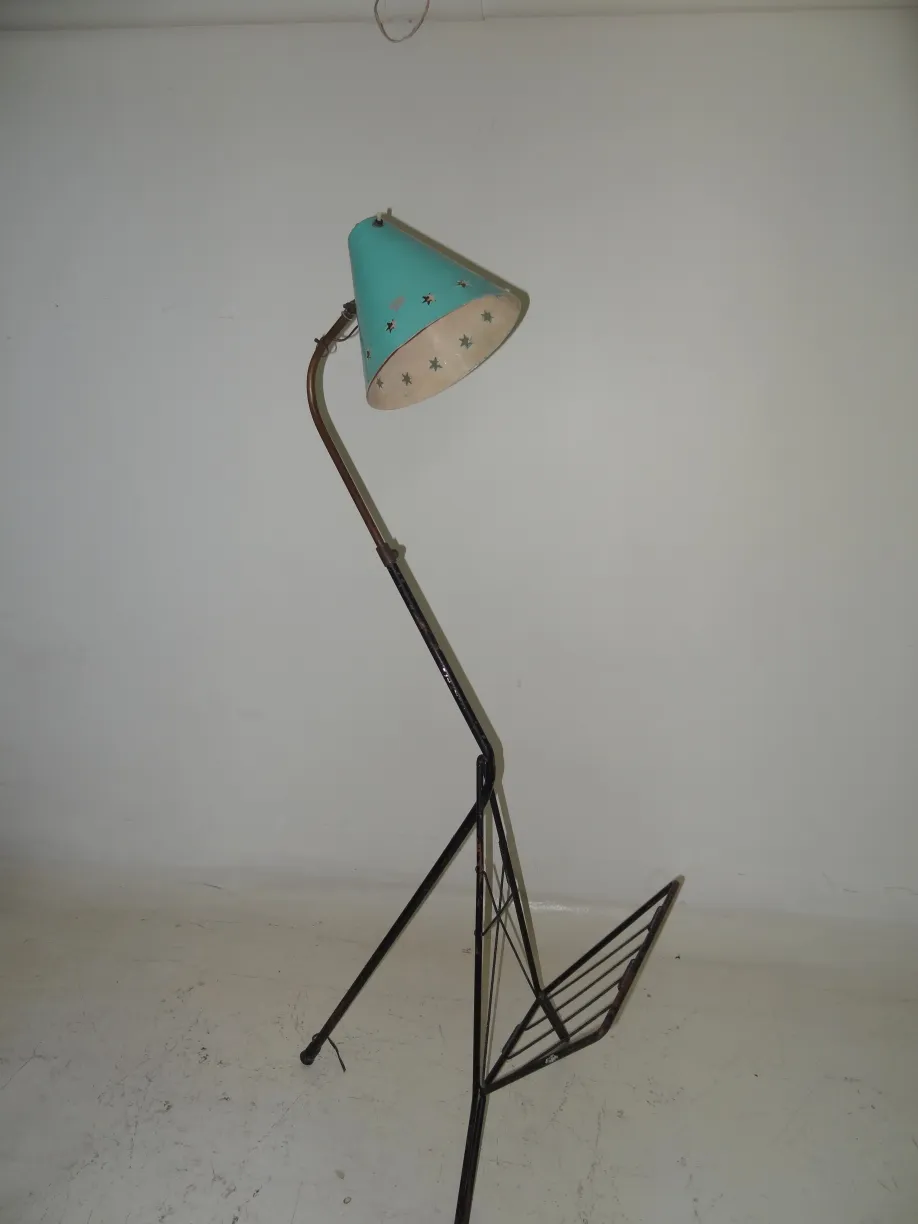 antique floor lamp with blue shade in a simple setting