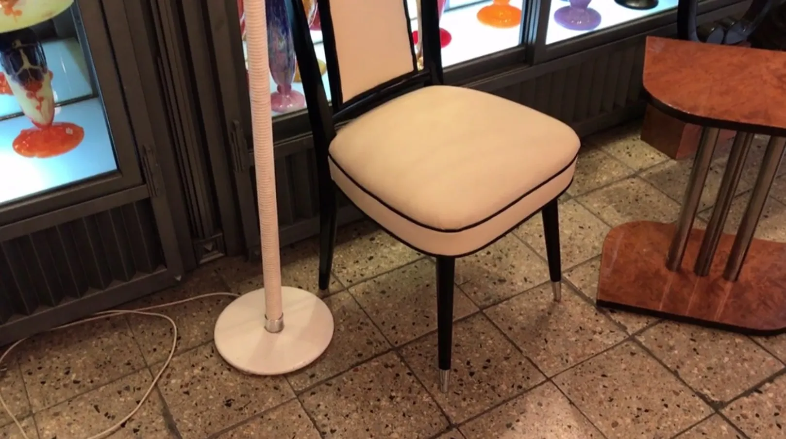 Antique floor lamp with a round base, soft light, cozy atmosphere.