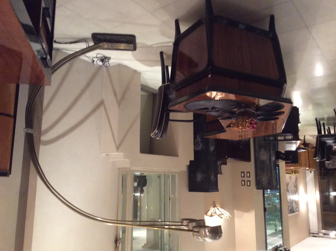 Antique floor lamp with curved base and shade, elegant atmosphere