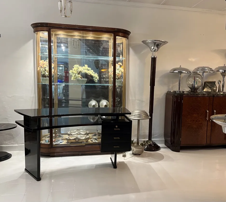 Set of two antique floor lamps in an elegant room, highlighted alongside vintage furniture.