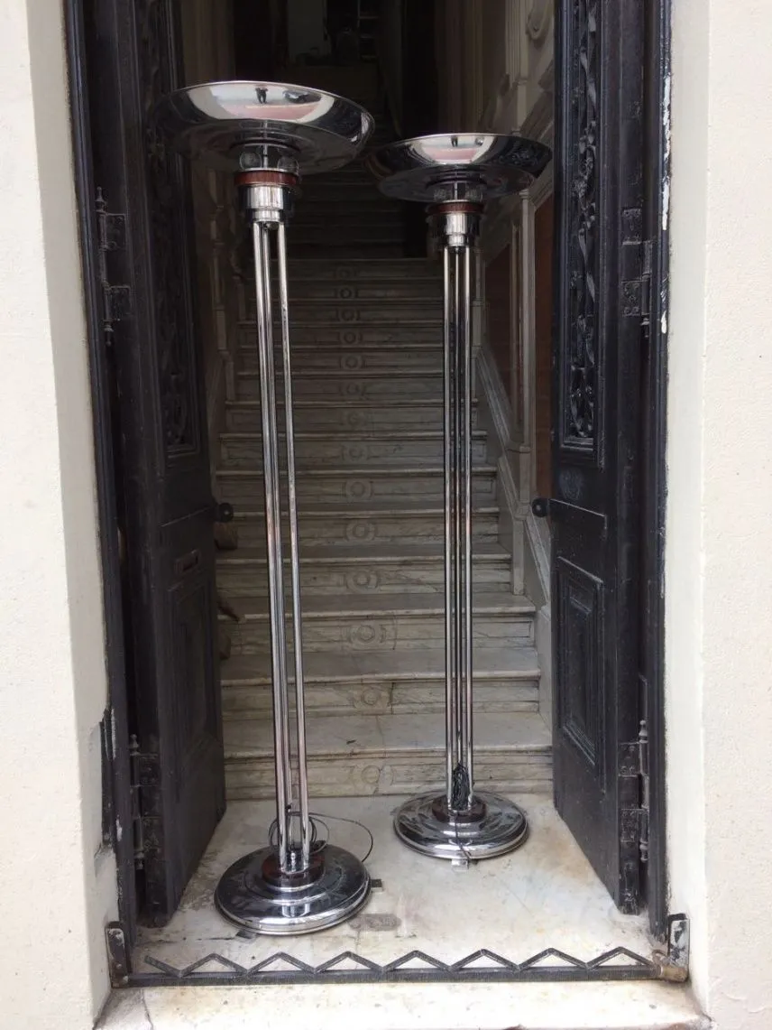 Set of 2 floor lamps in an elegant antique setting, featuring shiny bases, perfect for enhancing any room.