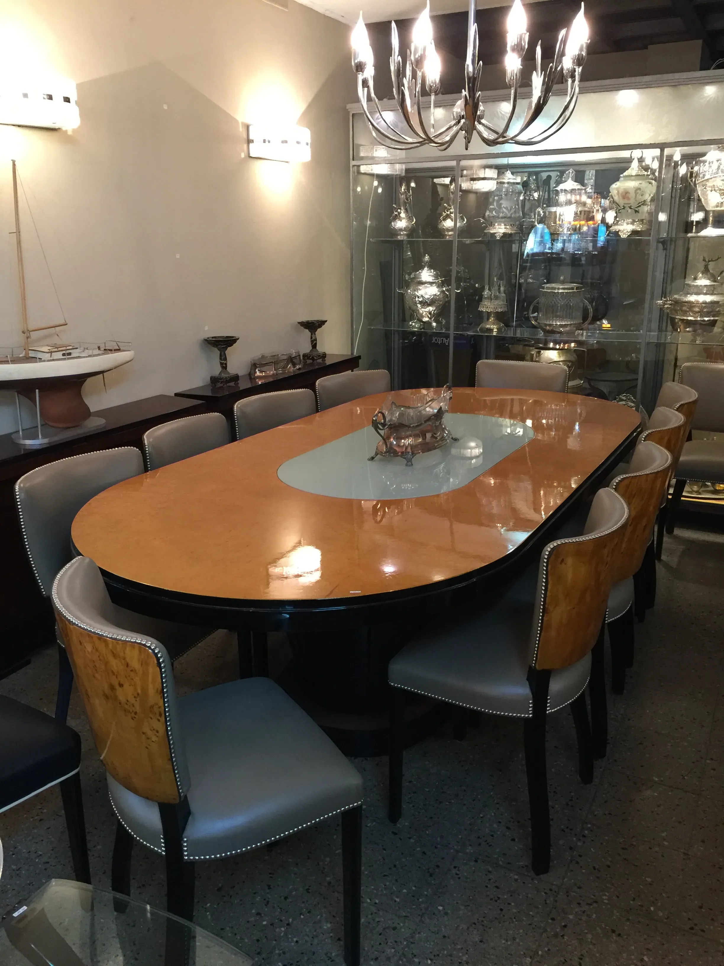 Antique dining table for 10 people with lighting in an elegant setting.