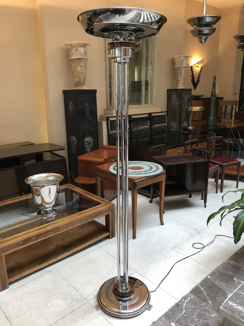 Two antique floor lamps, elegant, in a classic furniture setting.