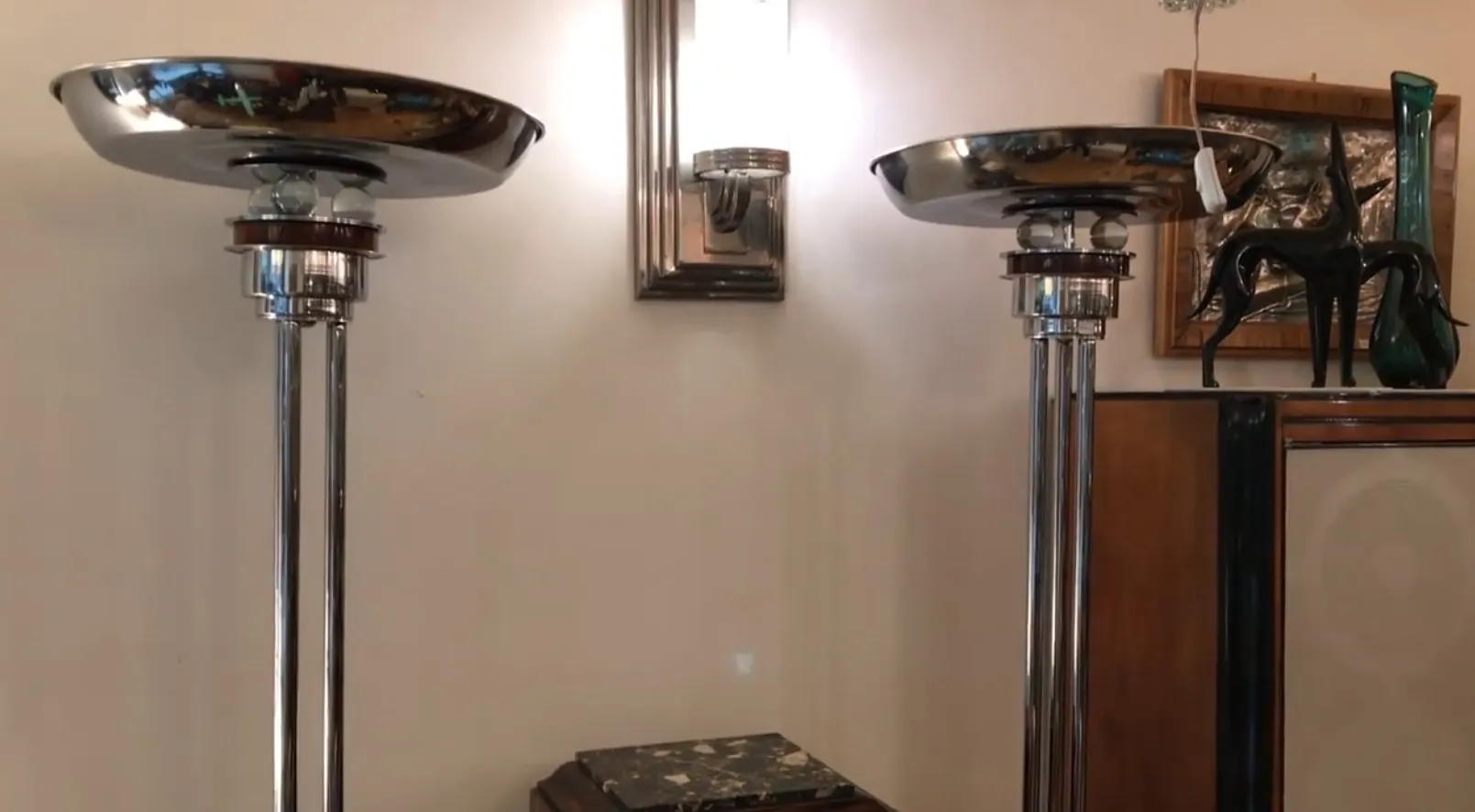 two antique floor lamps with a metallic base and elegant shades