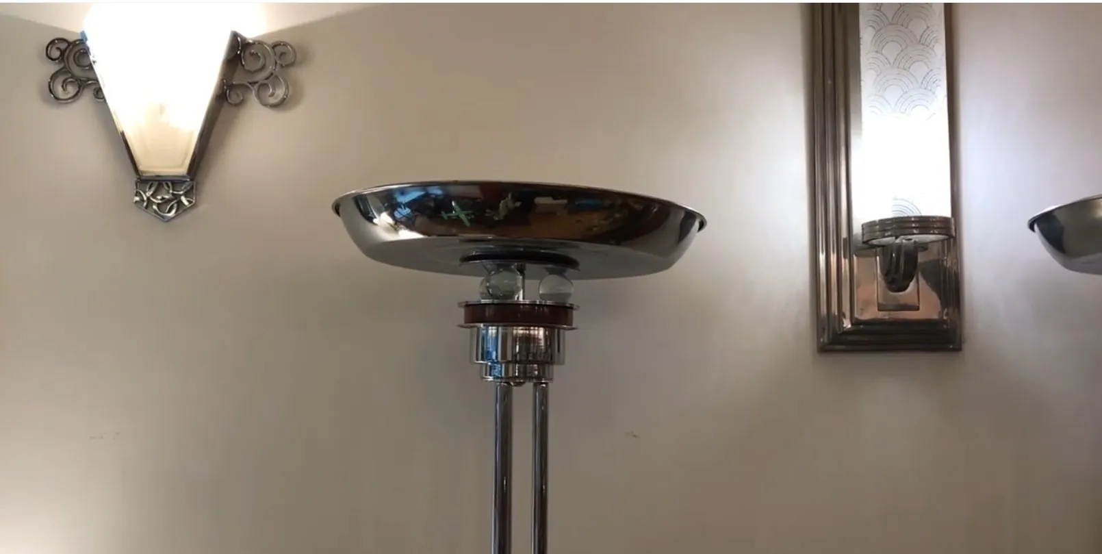 2 lámparas de pie antiguas con base de metal y diseño estilizado, decoran el ambiente