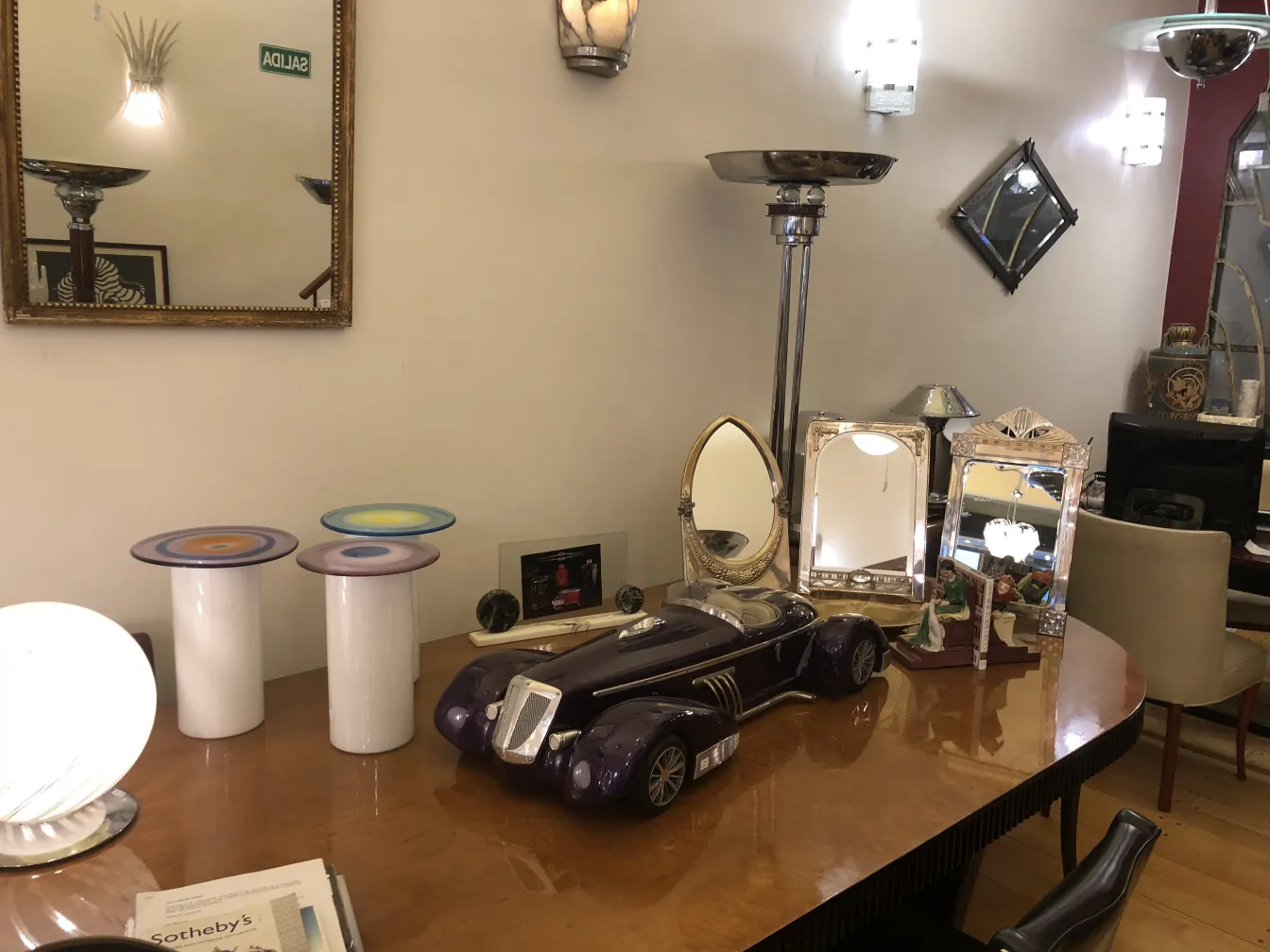 2 antique floor lamps in stylish setting with a mirror