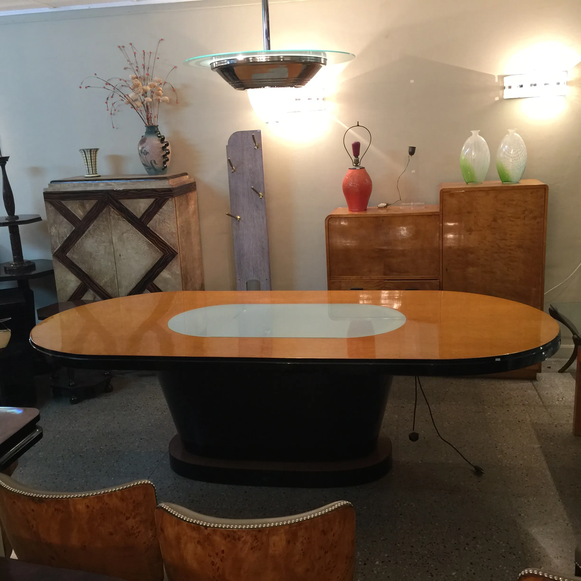 Mesa antiga de jantar para dez pessoas com luz em ambiente elegante