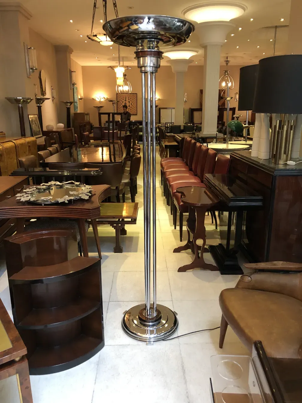 two antique floor lamps with glossy bases in a warm setting