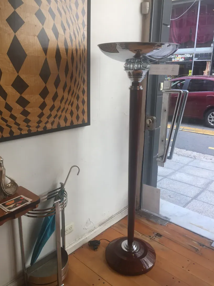 2 antique floor lamps with a wooden base and shiny shade, set in a timeless environment.