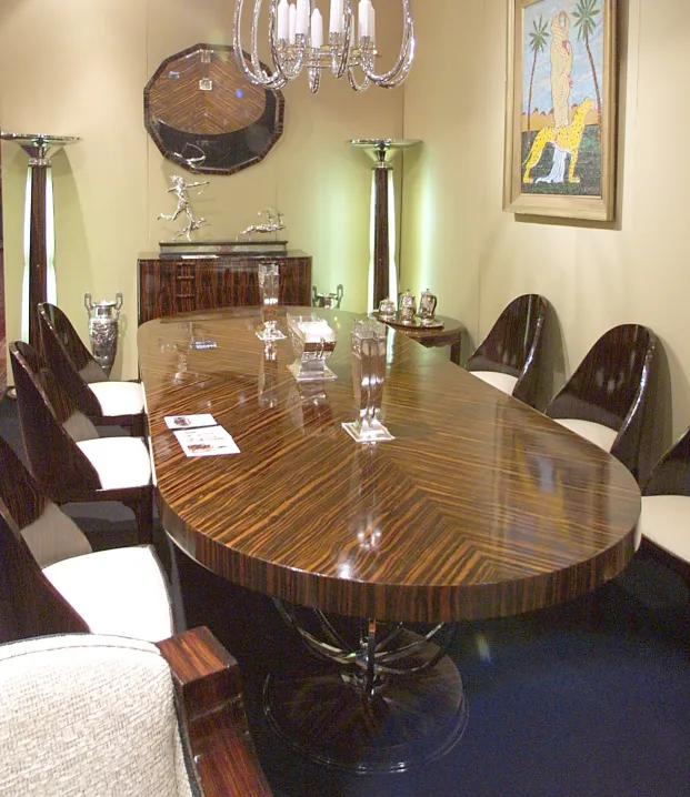 two antique floor lamps in an elegant living room with a long table and chairs.