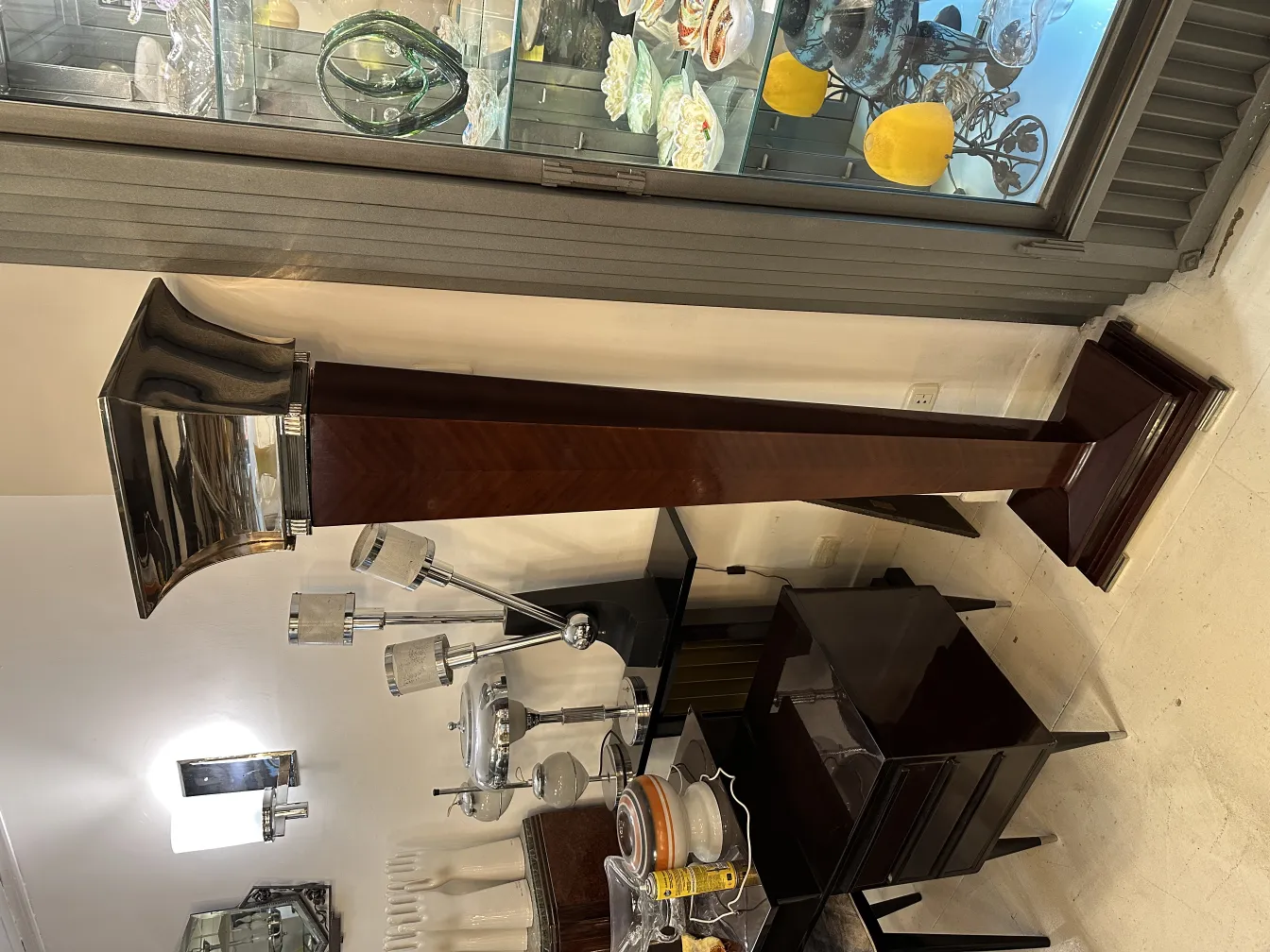 Set of 2 antique floor lamps in an elegant setting with tables.