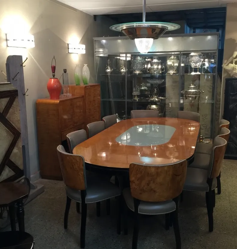 Antique dining table for 10 people with elegant chairs and lighting