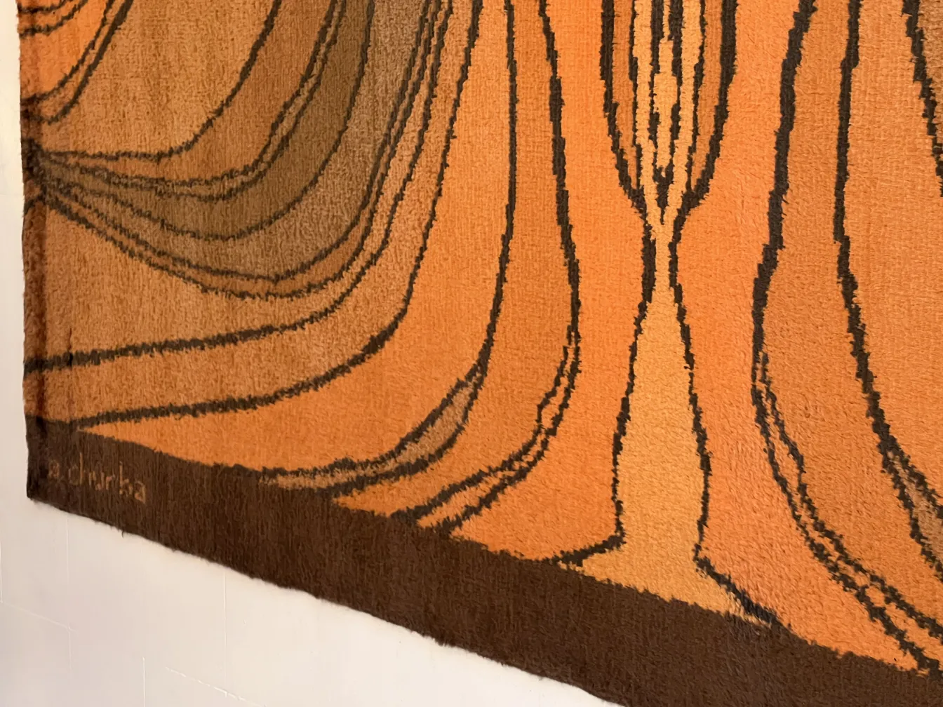 vintage carpet featuring brown and orange abstract patterns