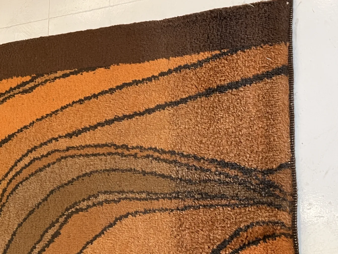 antique carpet in orange and brown with pattern