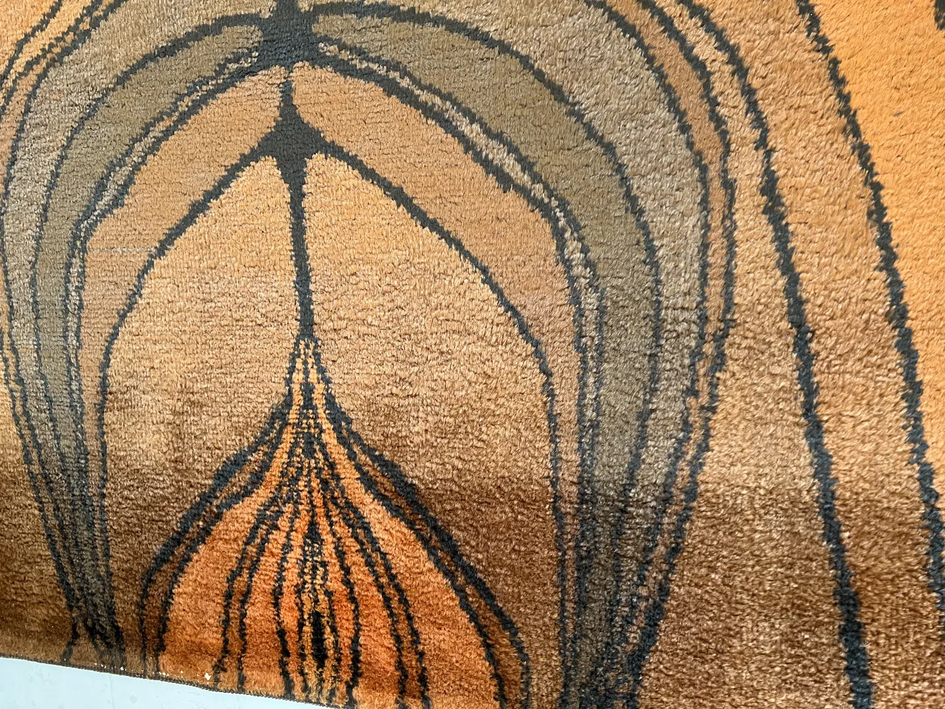 antique carpet with abstract pattern in brown tones