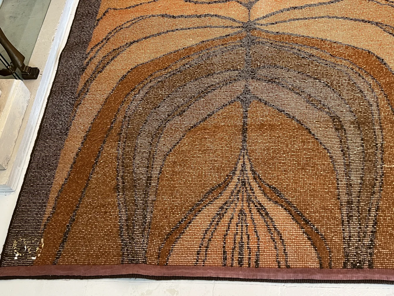 antique carpet with abstract design in brown tones