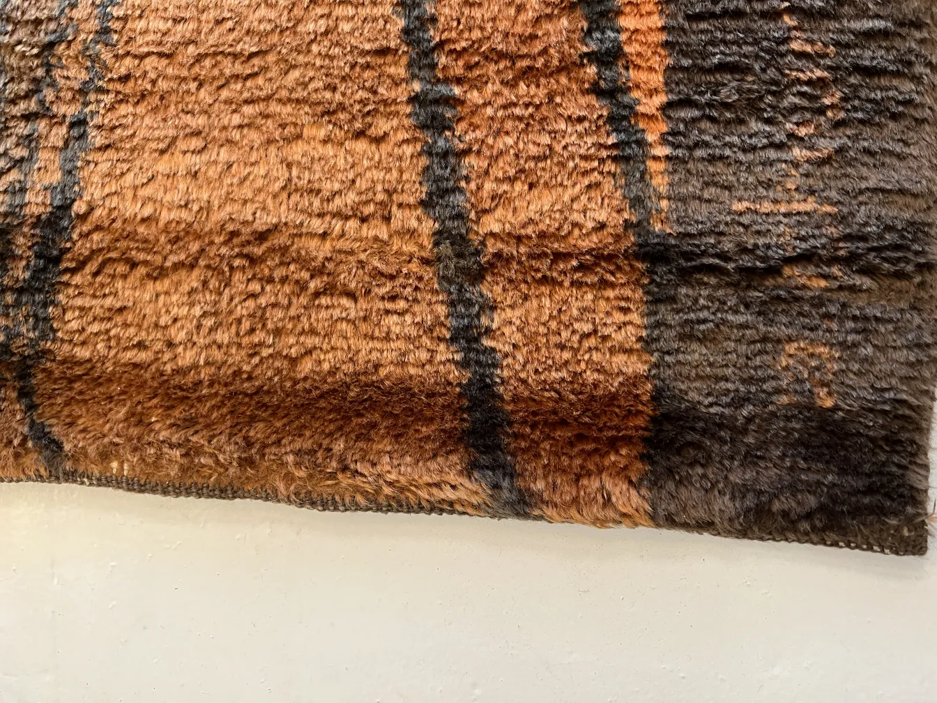 antique carpet with warm colors and striped design