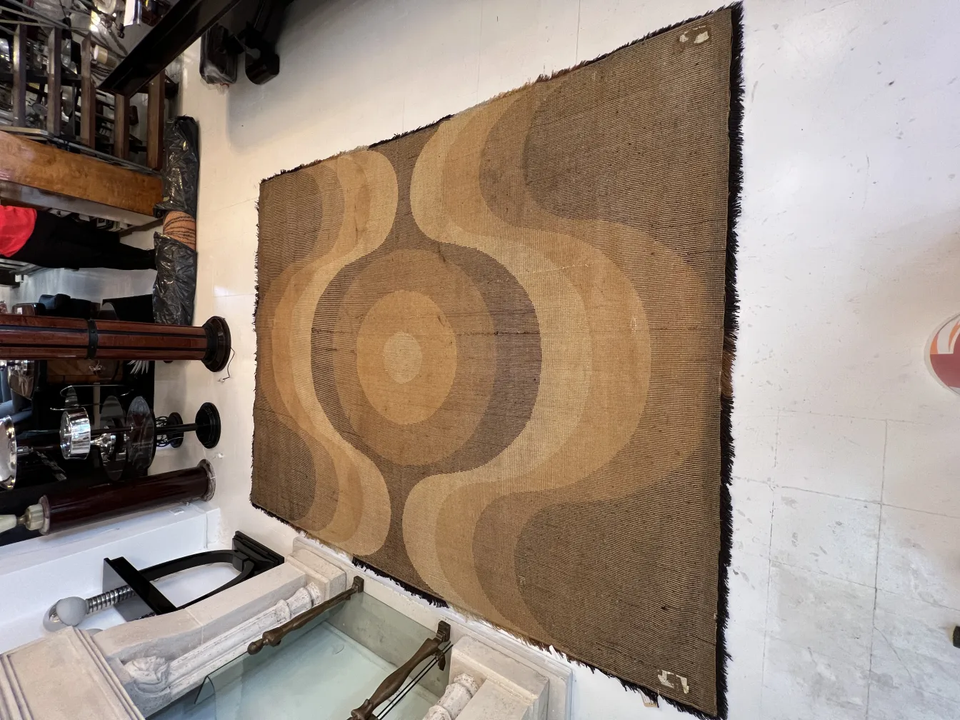 Antique carpet featuring geometric patterns in a classic setting.