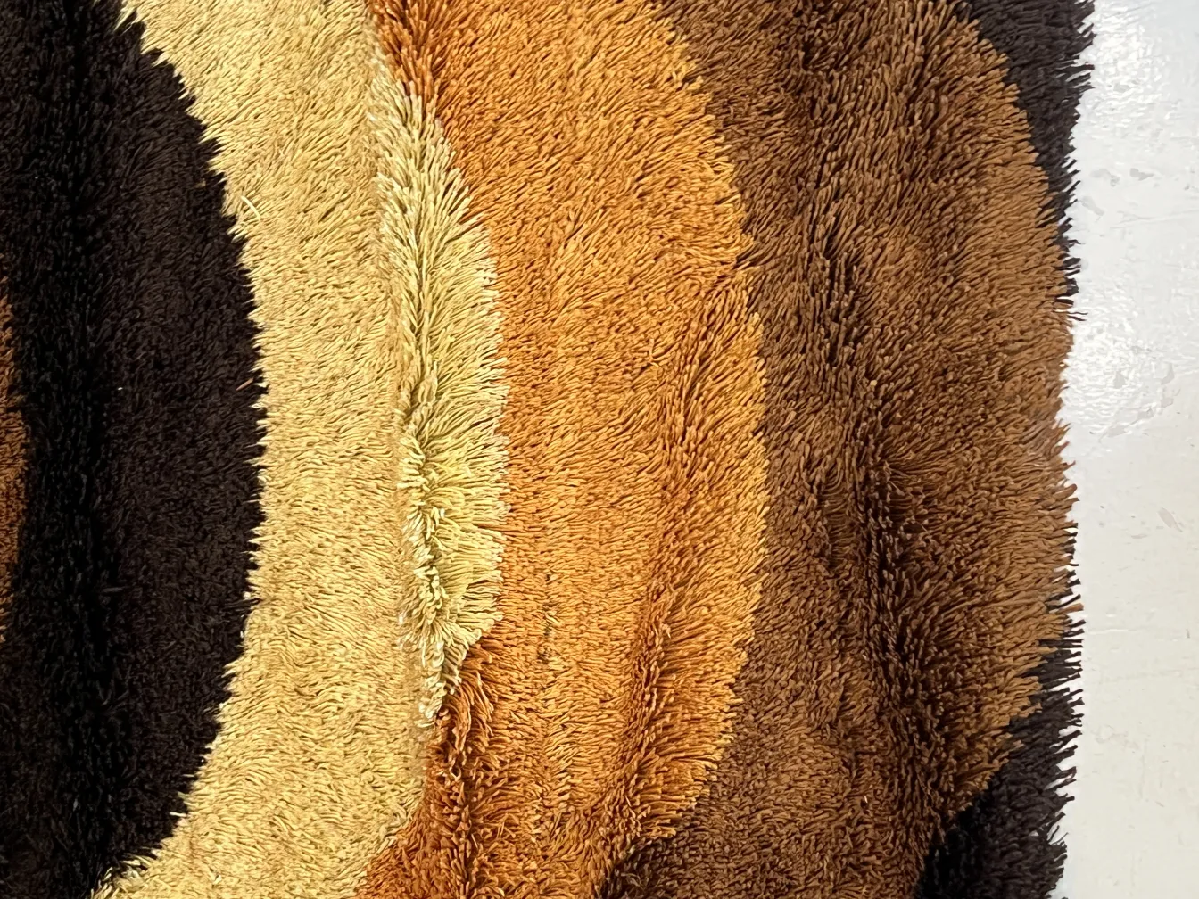 antique carpet with brown and beige patterns, in a cozy setting