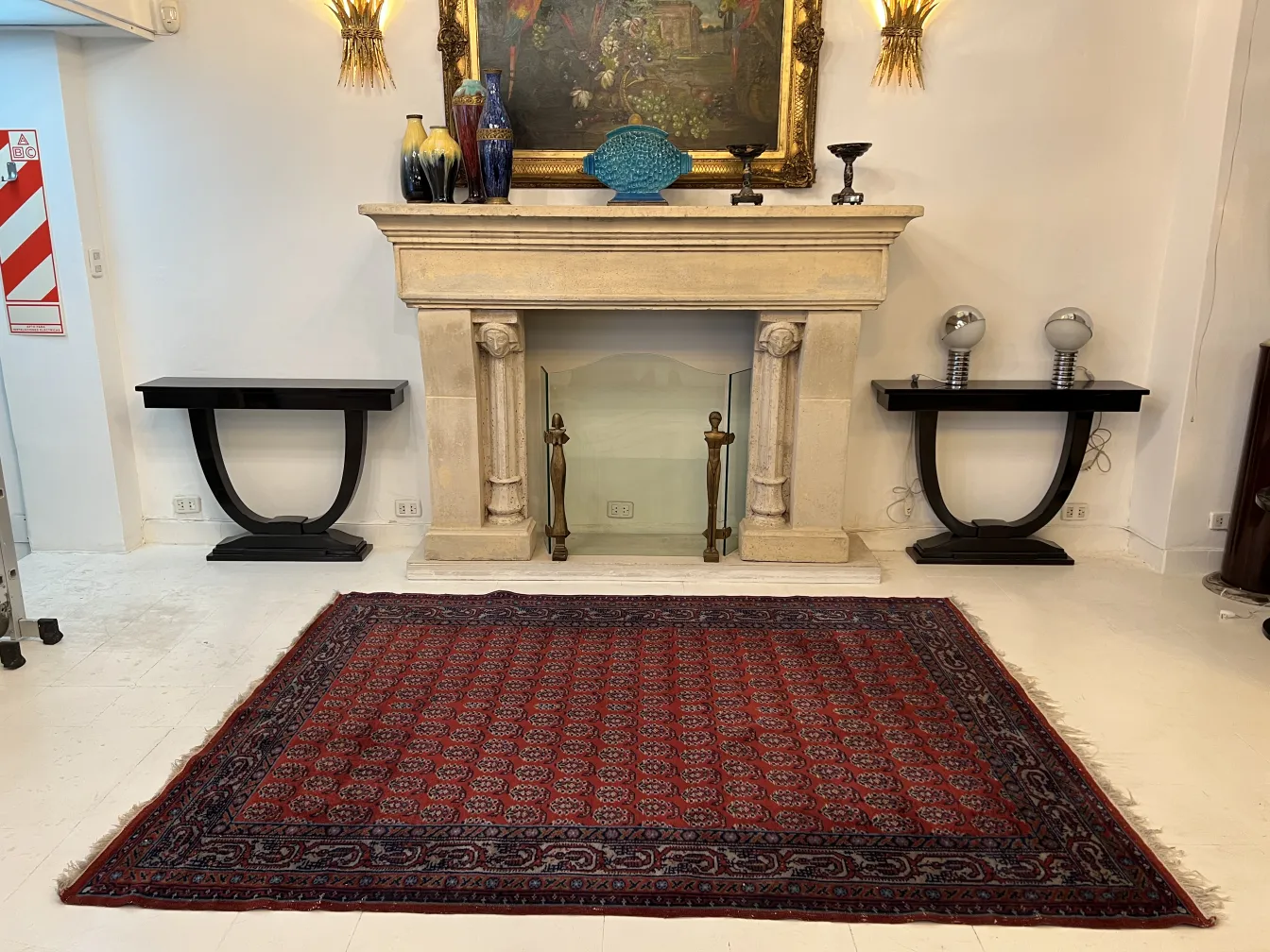 Antique carpet with red and blue patterns, in an elegant setting.