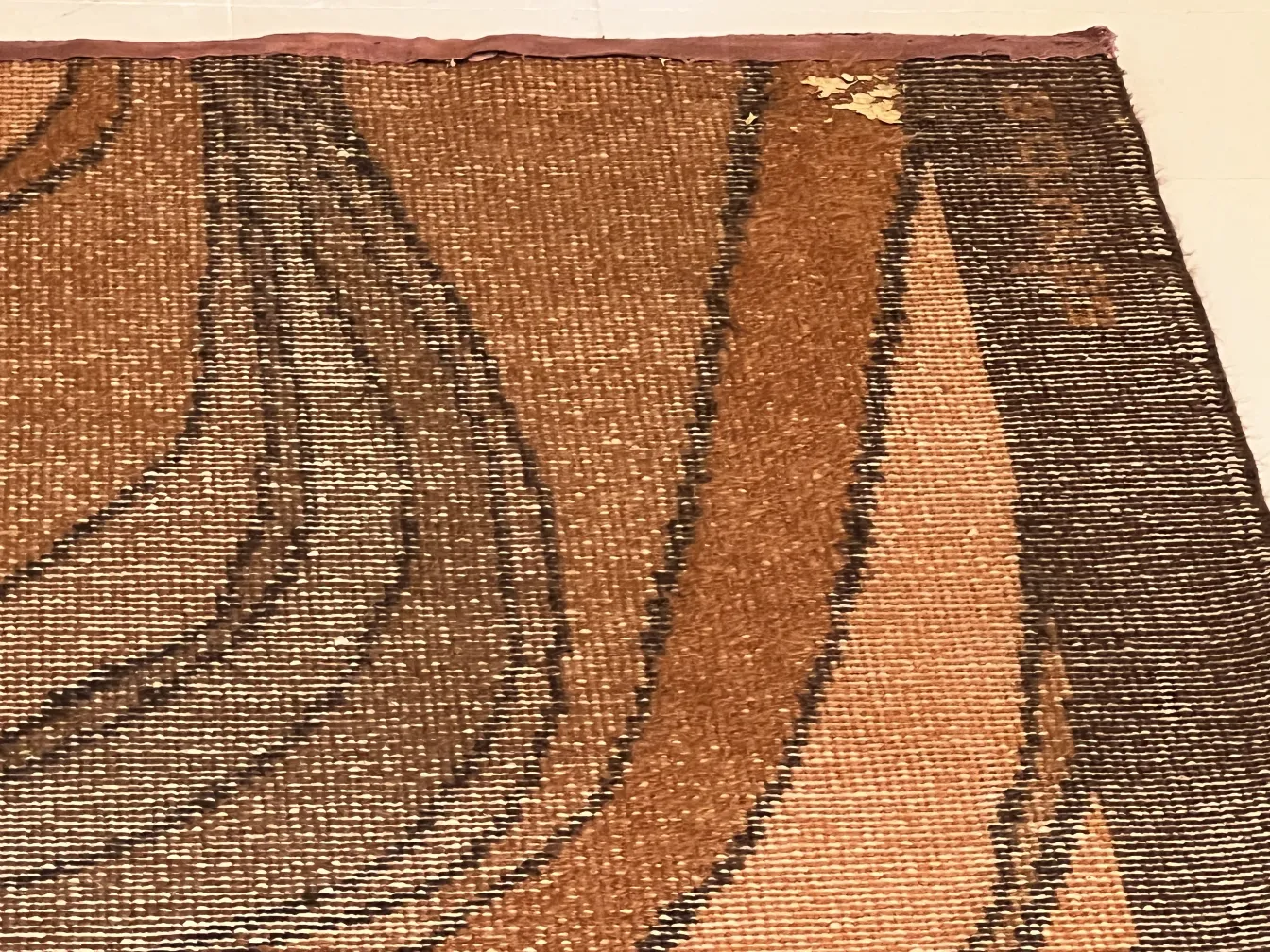 antique carpet with patterns in brown and beige tones