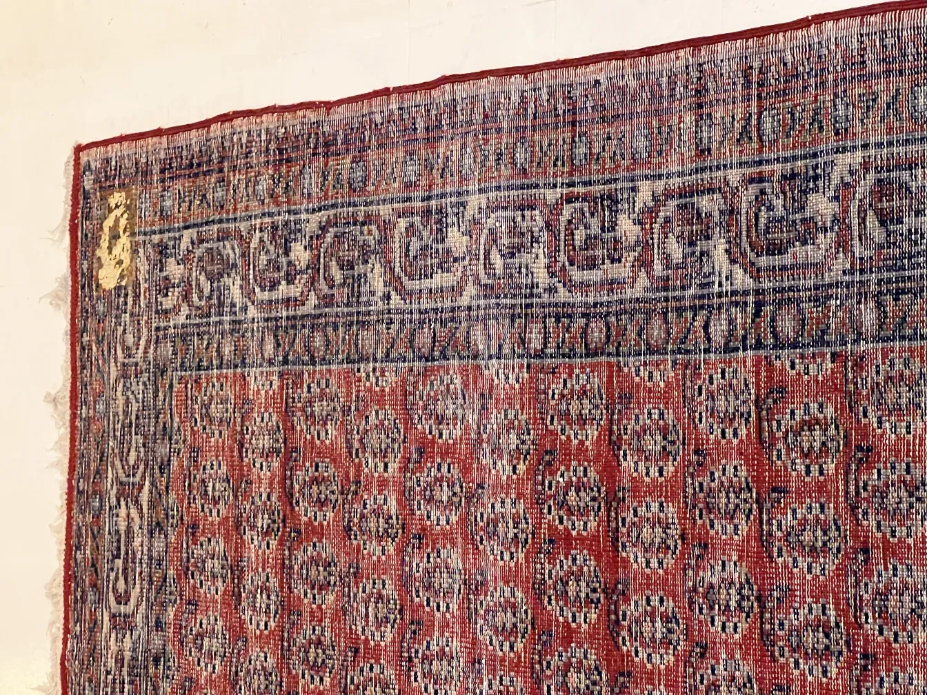 antique decorative carpet featuring colorful patterns