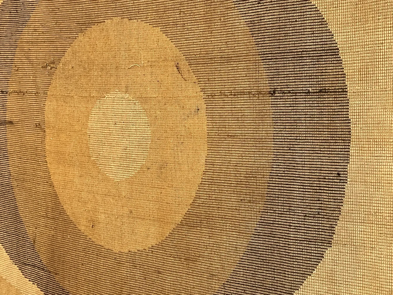 antique carpet with circular patterns on beige background