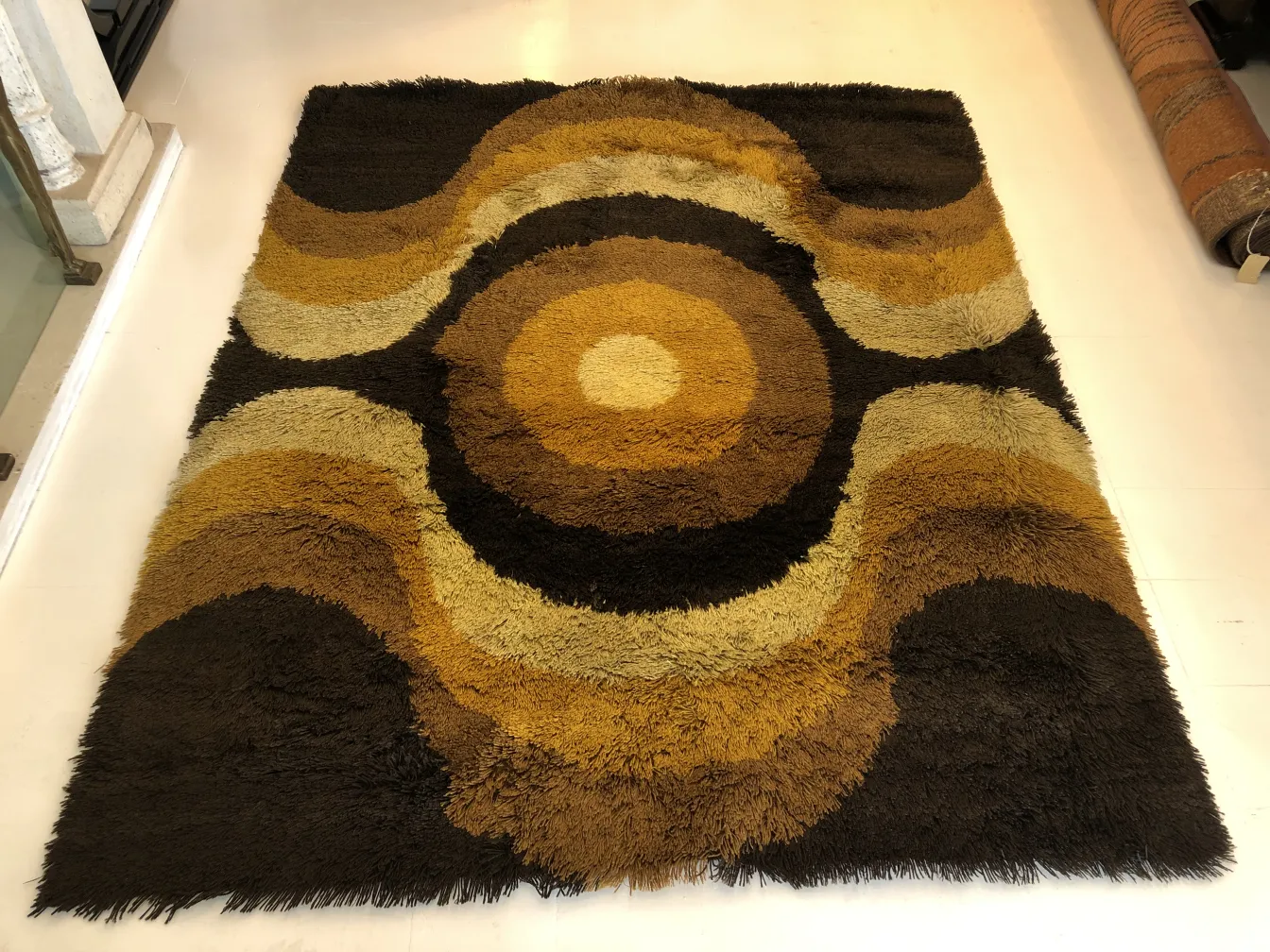 antique carpet with circular patterns in earthy colors, decorative