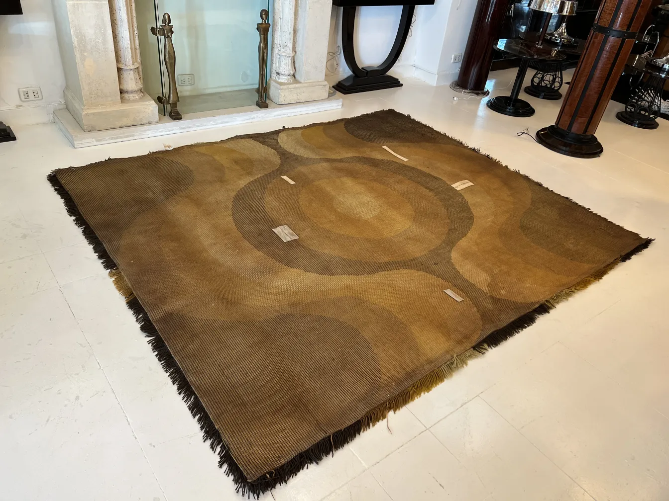 antique carpet in brown tones with wavy patterns in the setting