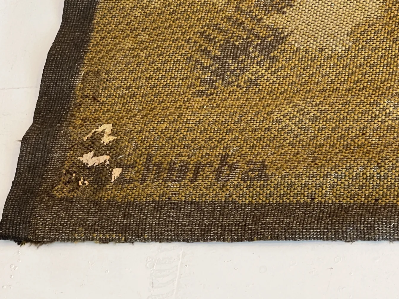 Antique carpet with classic design and visible wear