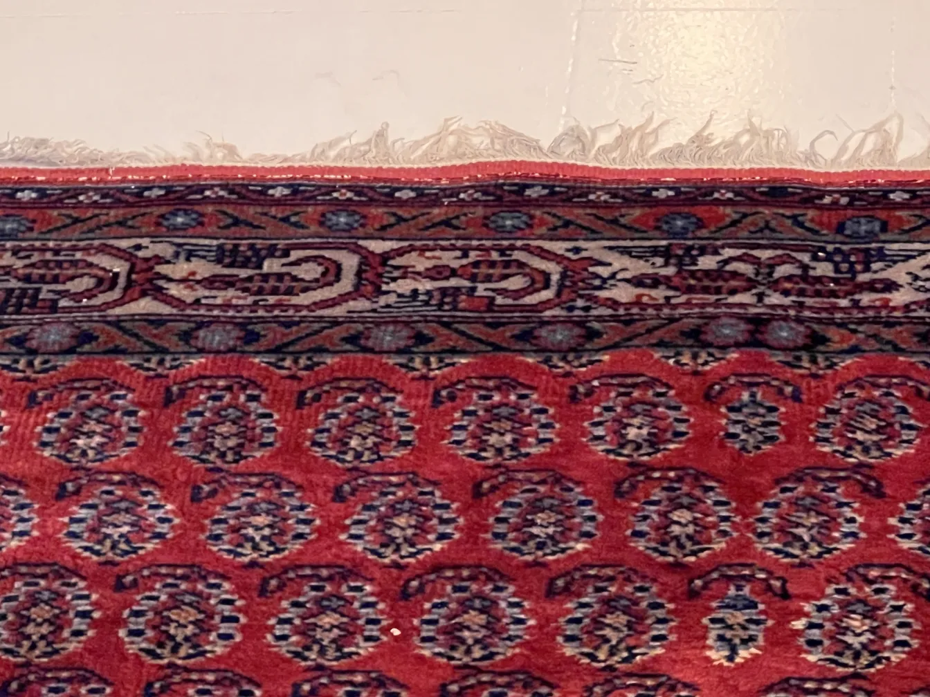 antique red carpet featuring a beautiful border pattern