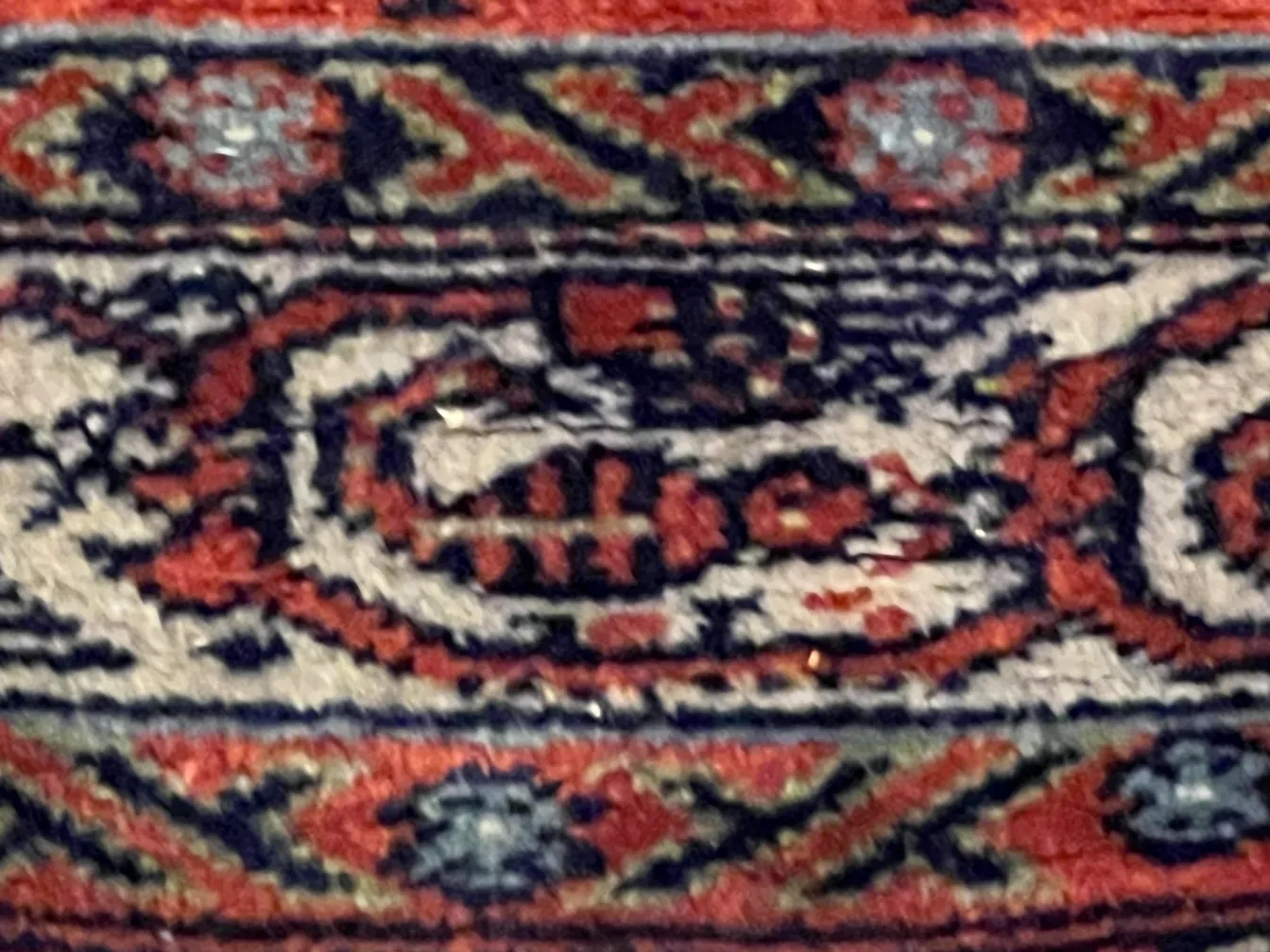 Antique carpet featuring vibrant animal designs.