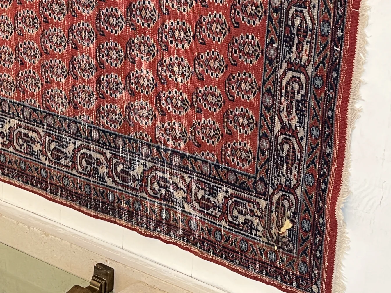 tapis ancien avec motif classique dans des tons chauds et des détails décoratifs