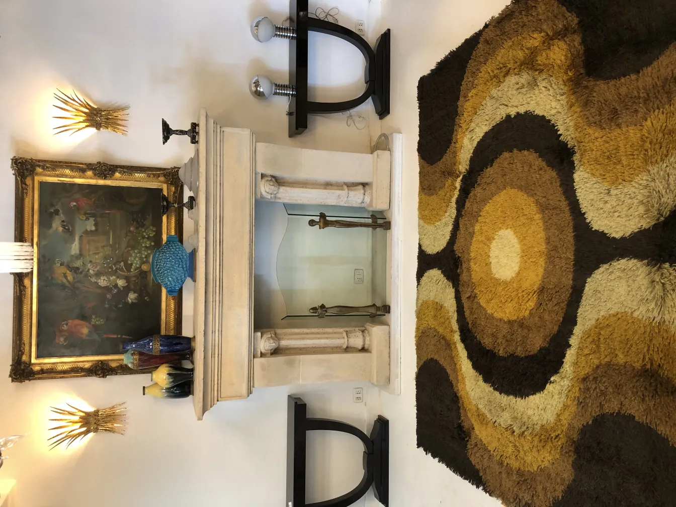 antique carpet with circular design in brown and beige colors, in an elegant setting with antique paintings