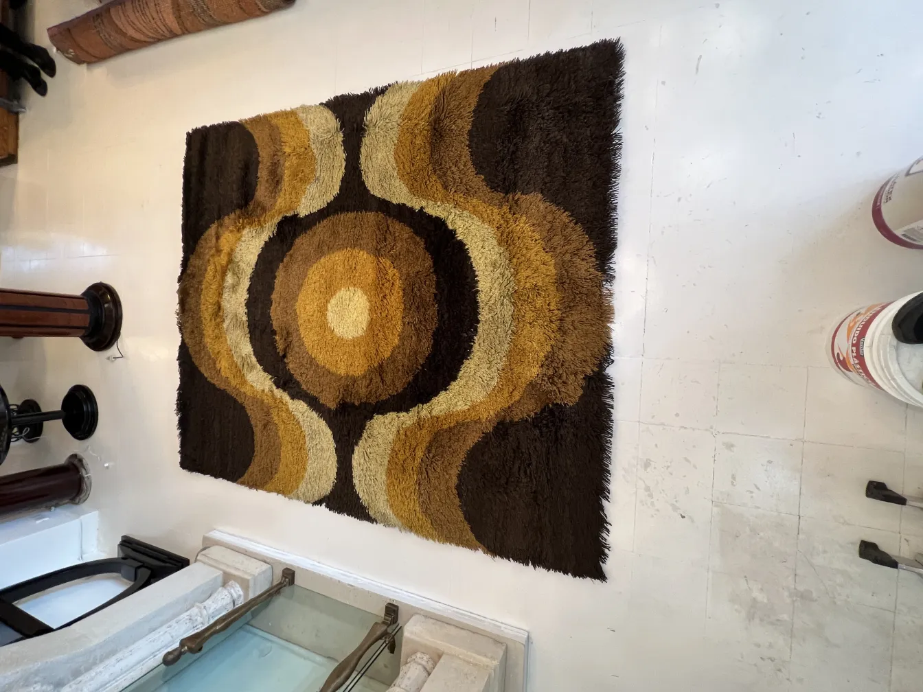 antique carpet with brown and yellow circular patterns