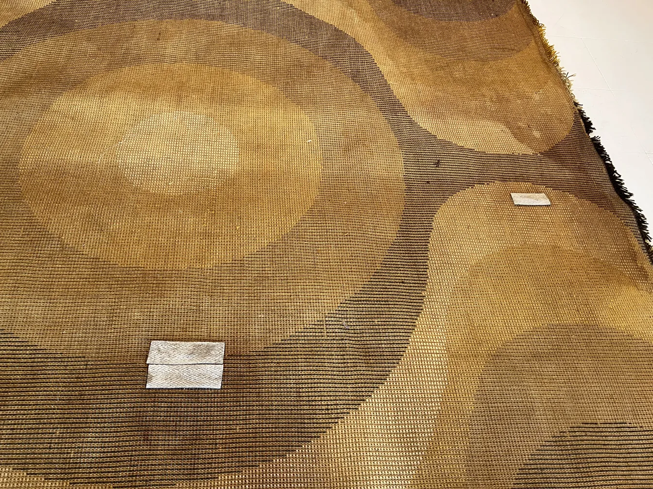 vintage carpet featuring brown and ochre circular designs