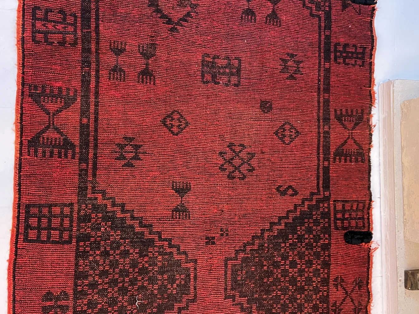 antique carpet with red and black patterns