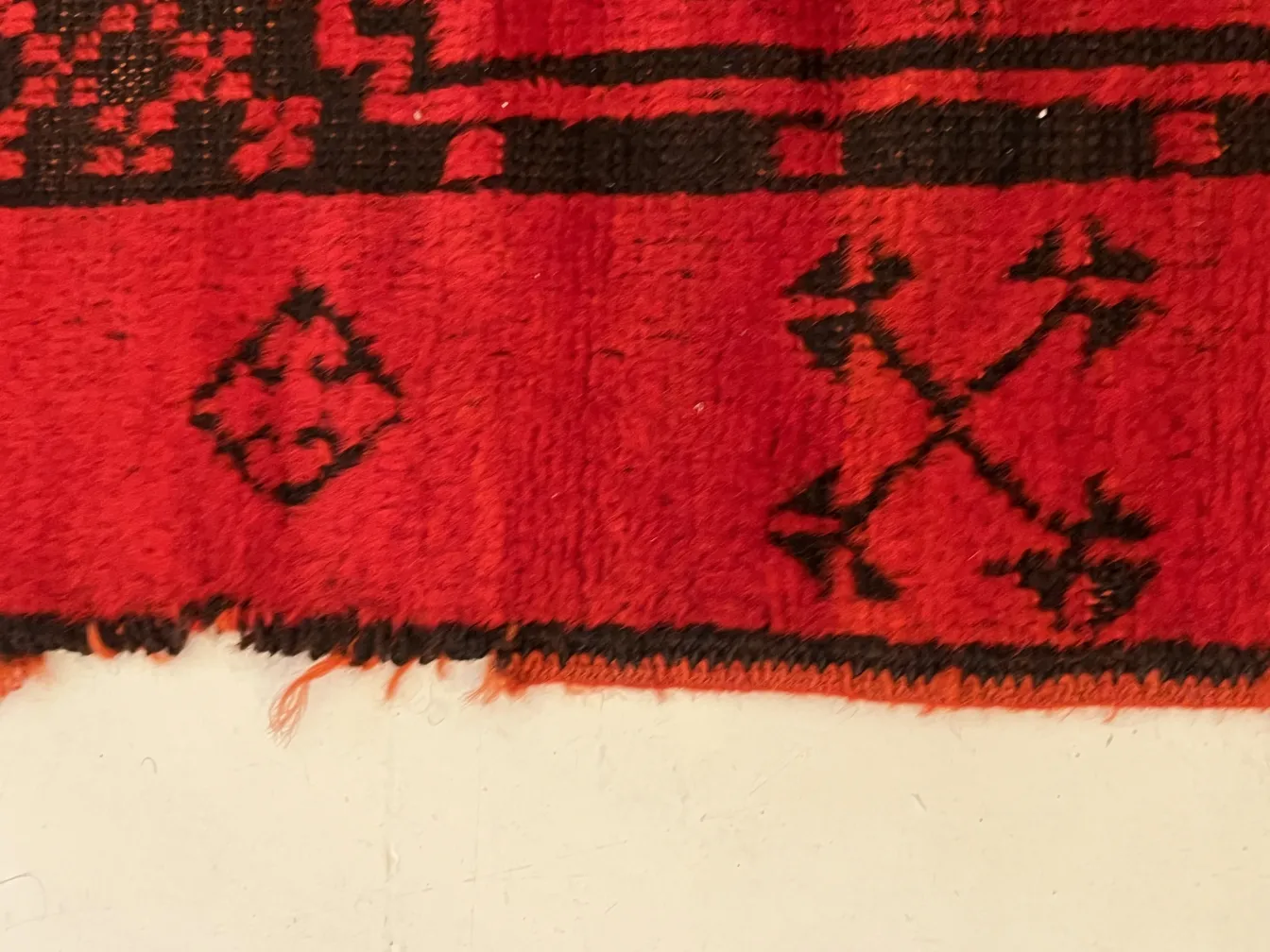 detail of antique red carpet with intricate patterns