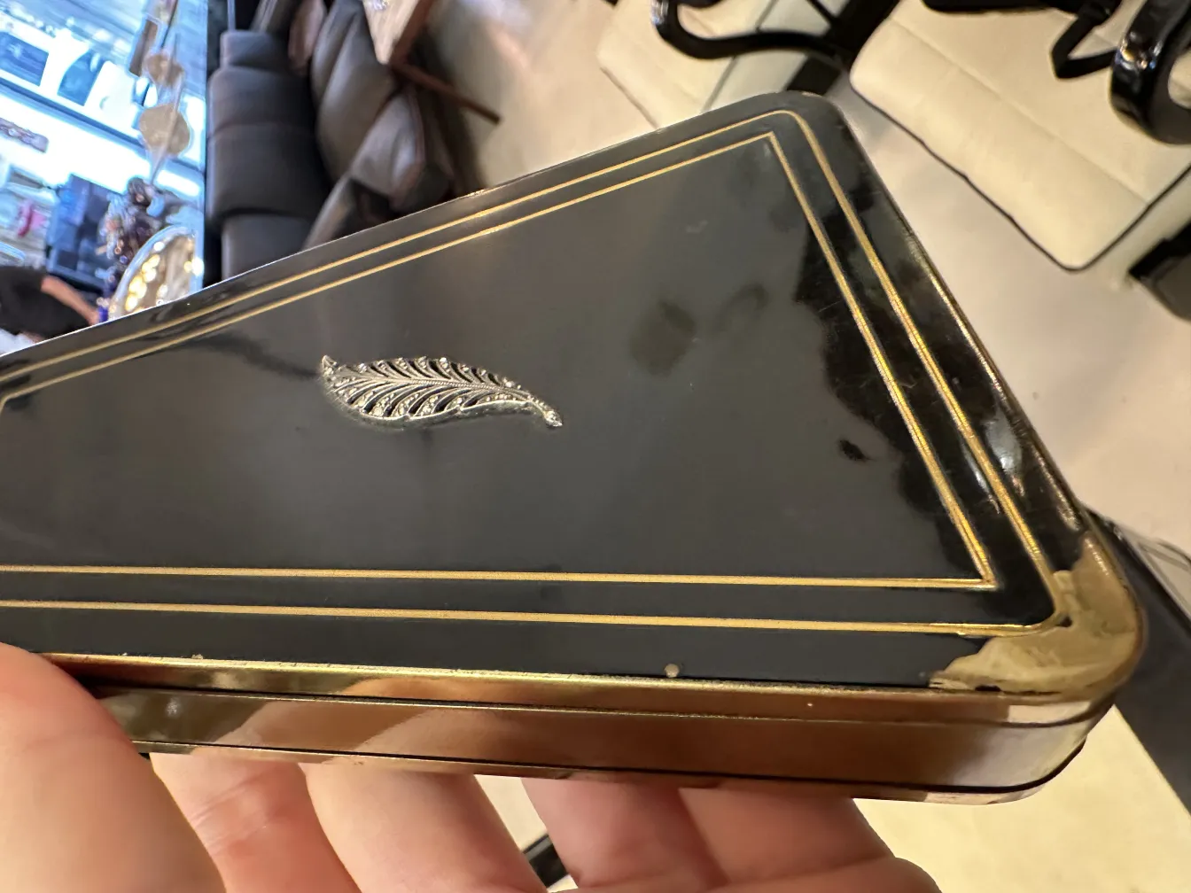 Antique Art Deco bag with gold details and a feather.