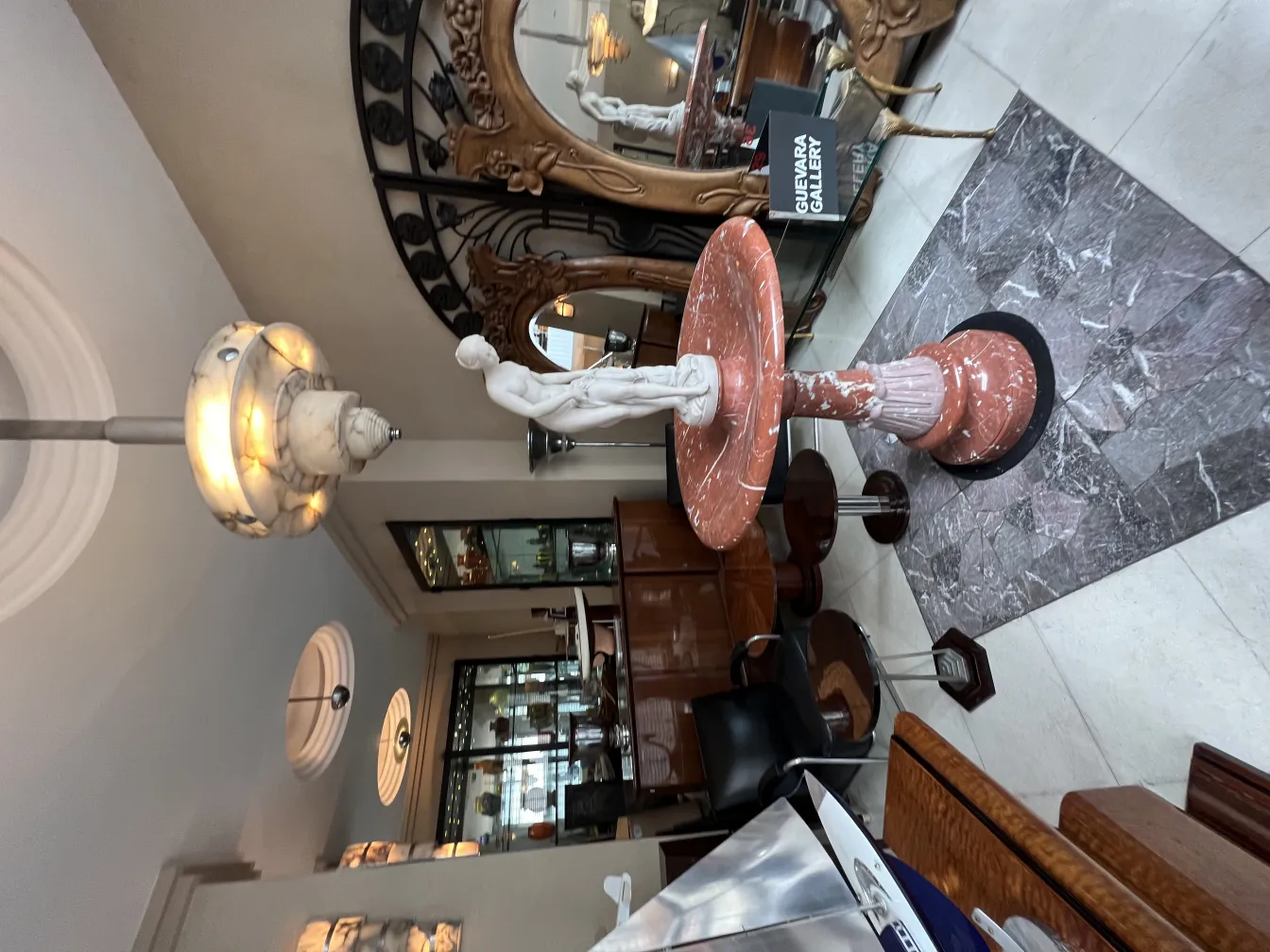 Antique decorative fountain in pink tones within an elegant setting.