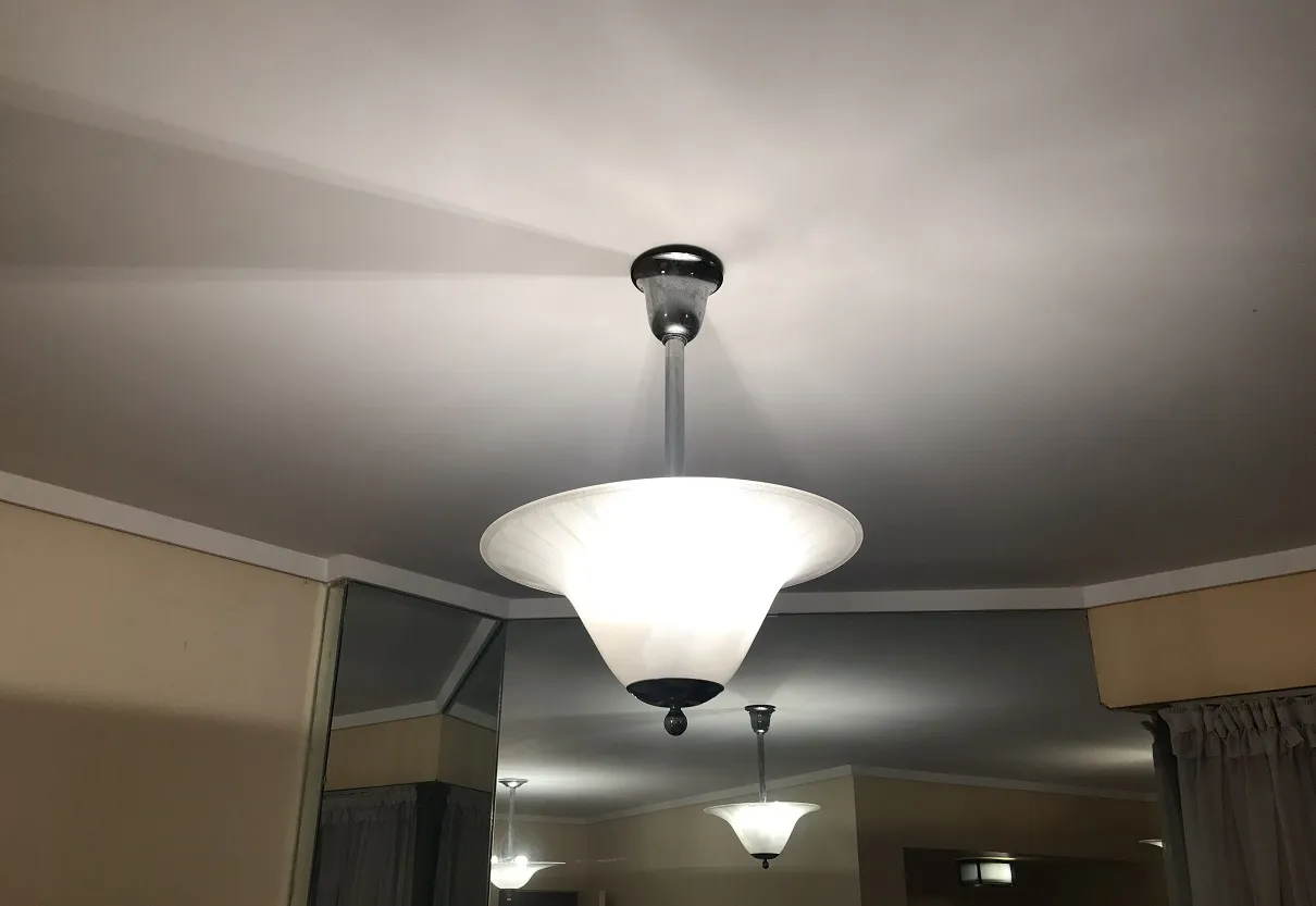 Set di due lampade a sospensione antiche in un ambiente accogliente, illuminate dolcemente.