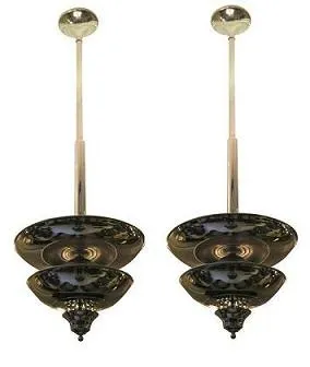 Two antique hanging lamps with an elegant design, illuminating a cozy setting.